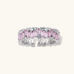 Adjustable eternity ring with alternating pink baguette and clear round cubic zirconia stones in palladium-plated setting