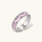 Adjustable eternity ring with alternating pink baguette and clear round cubic zirconia stones in palladium-plated setting