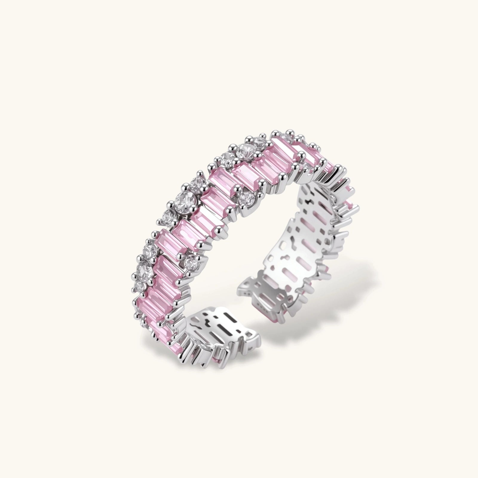 Adjustable eternity ring with alternating pink baguette and clear round cubic zirconia stones in palladium-plated setting