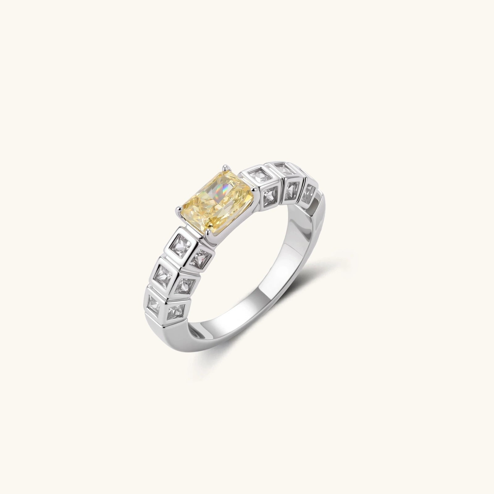 Adjustable ring with emerald-cut yellow zirconia center and clear accent stones in geometric platinum-plated setting