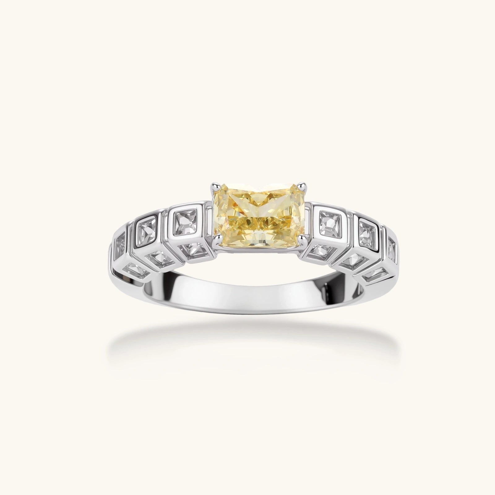 Adjustable ring with emerald-cut yellow zirconia center and clear accent stones in geometric platinum-plated setting