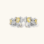 Close-up of platinum-plated copper eternity ring featuring alternating yellow and clear marquise-cut stones in elegant band setting.