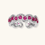 Ornate adjustable ring with pink cubic zirconia stones in white gold-plated copper setting with floral metalwork details