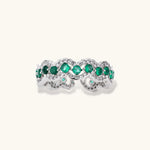 Platinum-plated copper ring with green zirconia stones in decorative scalloped wave pattern, adjustable band design.