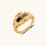 Ornate 18K gold-plated ring with black enamel center featuring star motif and decorative baroque-style edges on white background.
