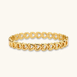 Gold 18K plated stainless steel bangle with continuous open heart links, high-polish finish, on white background.