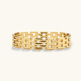 Wide 18K gold plated stainless steel bracelet with a multi-row rectangular grid link chain pattern on a cream background.
