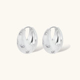 Silver-plated hoop earrings with star cutout designs, shown open and closed on white background, 17mm diameter.