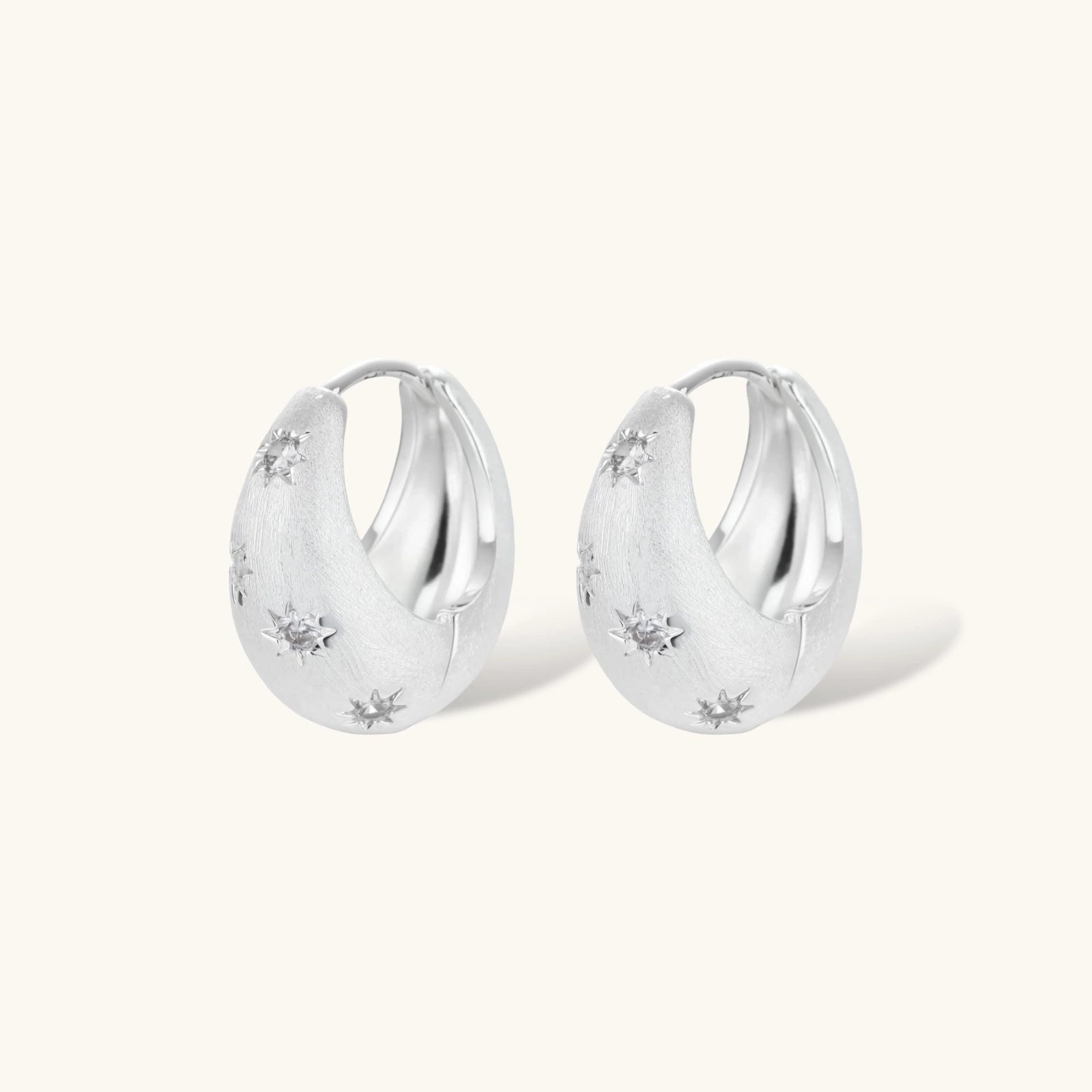 Silver-plated hoop earrings with star cutout designs, shown open and closed on white background, 17mm diameter.