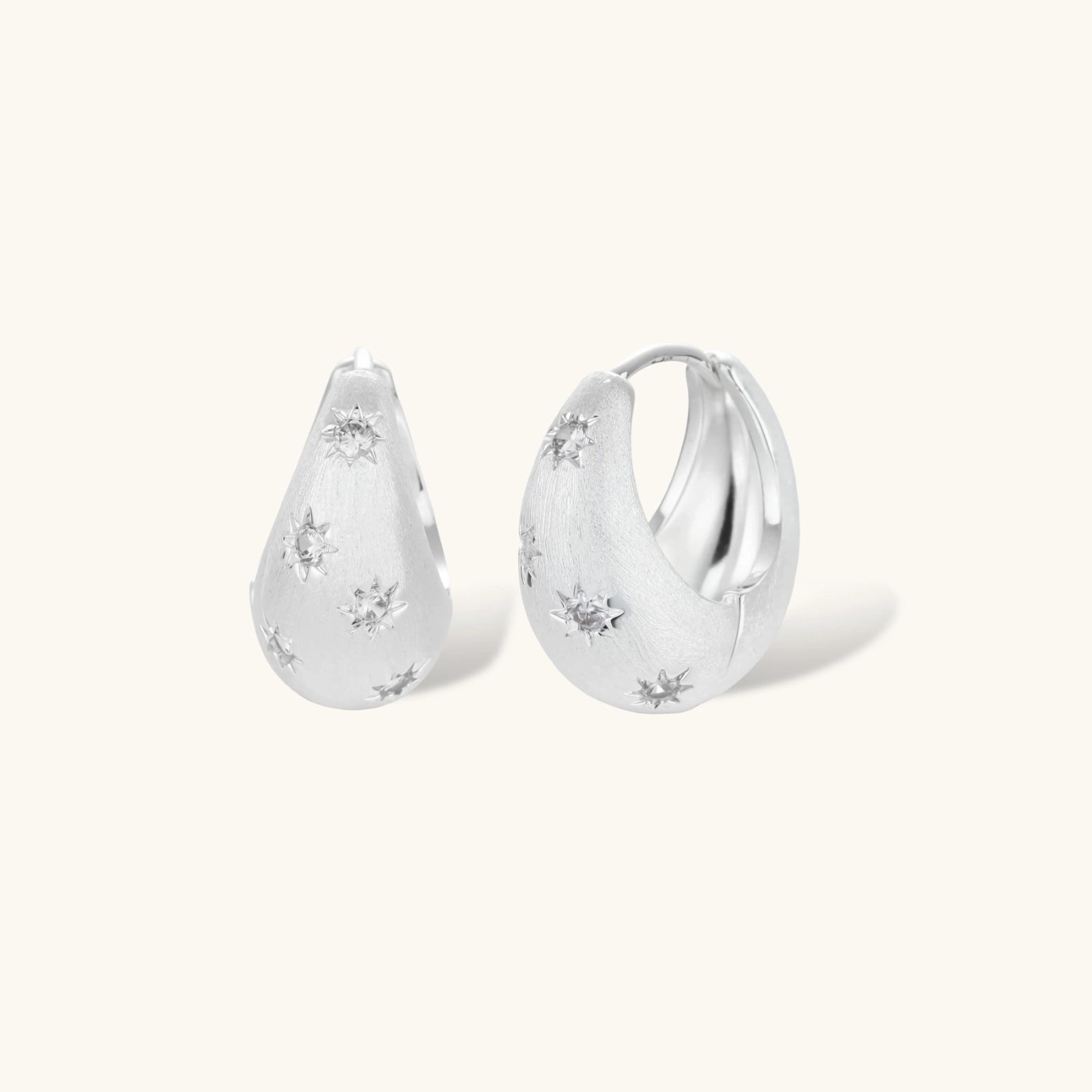 Silver-plated hoop earrings with star cutout designs, shown open and closed on white background, 17mm diameter.