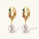 Ornate gold-plated hoop earrings with emerald, ruby, and sapphire accents, featuring dangling baroque freshwater pearls