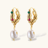 Ornate gold-plated hoop earrings with emerald, ruby, and sapphire accents, featuring dangling baroque freshwater pearls