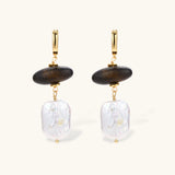 Gold hoop earrings with dark wood beads and baroque freshwater pearls, shown from multiple angles on cream background.