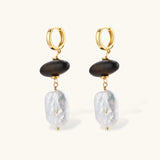 Gold hoop earrings with dark wood beads and baroque freshwater pearls, shown from multiple angles on cream background.