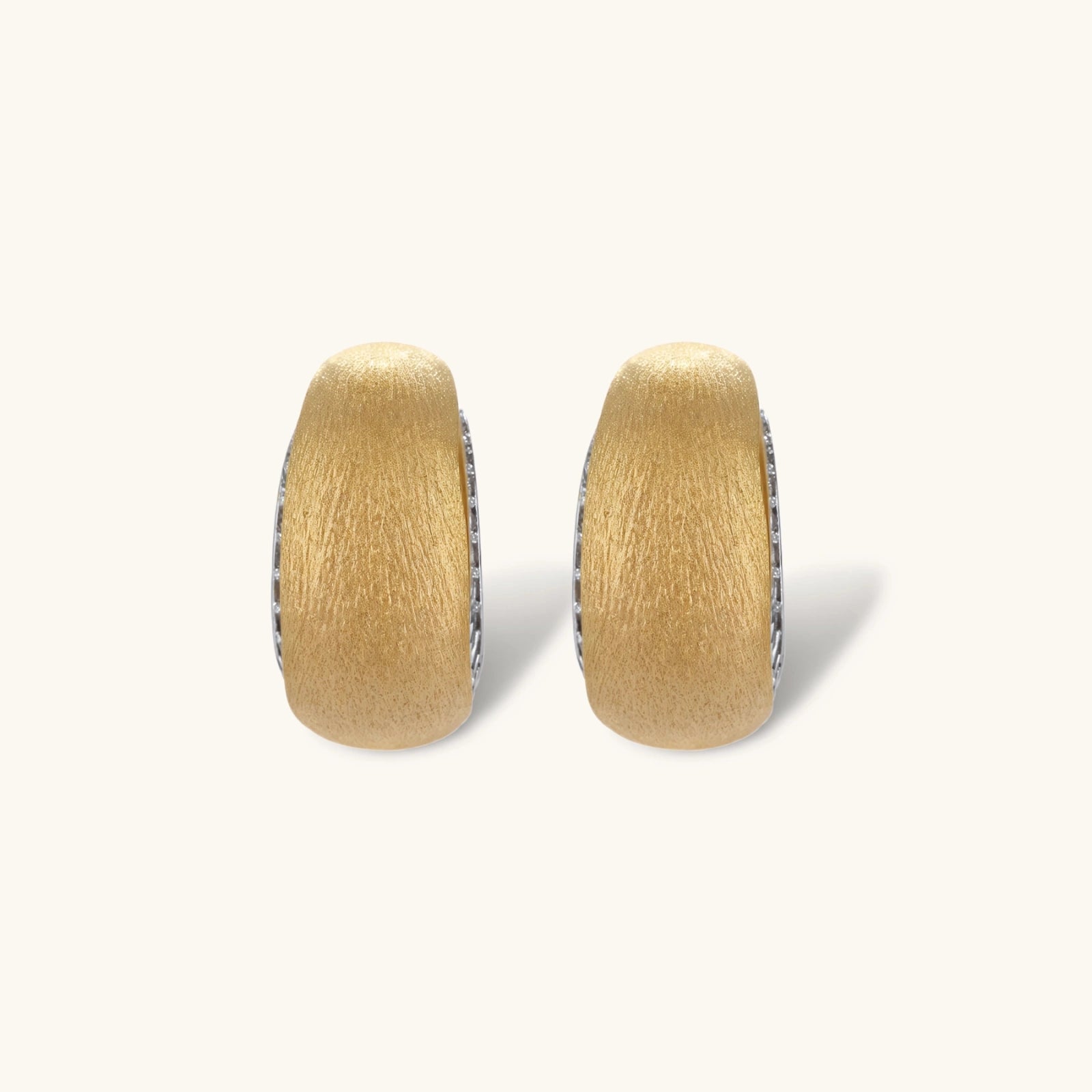 Small gold-plated hoop earrings with crystal accents and brushed finish on white background.
