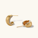 Small gold-plated hoop earrings with crystal accents and brushed finish on white background.