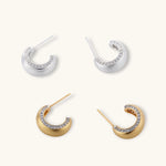Small gold-plated hoop earrings with crystal accents and brushed finish on white background.