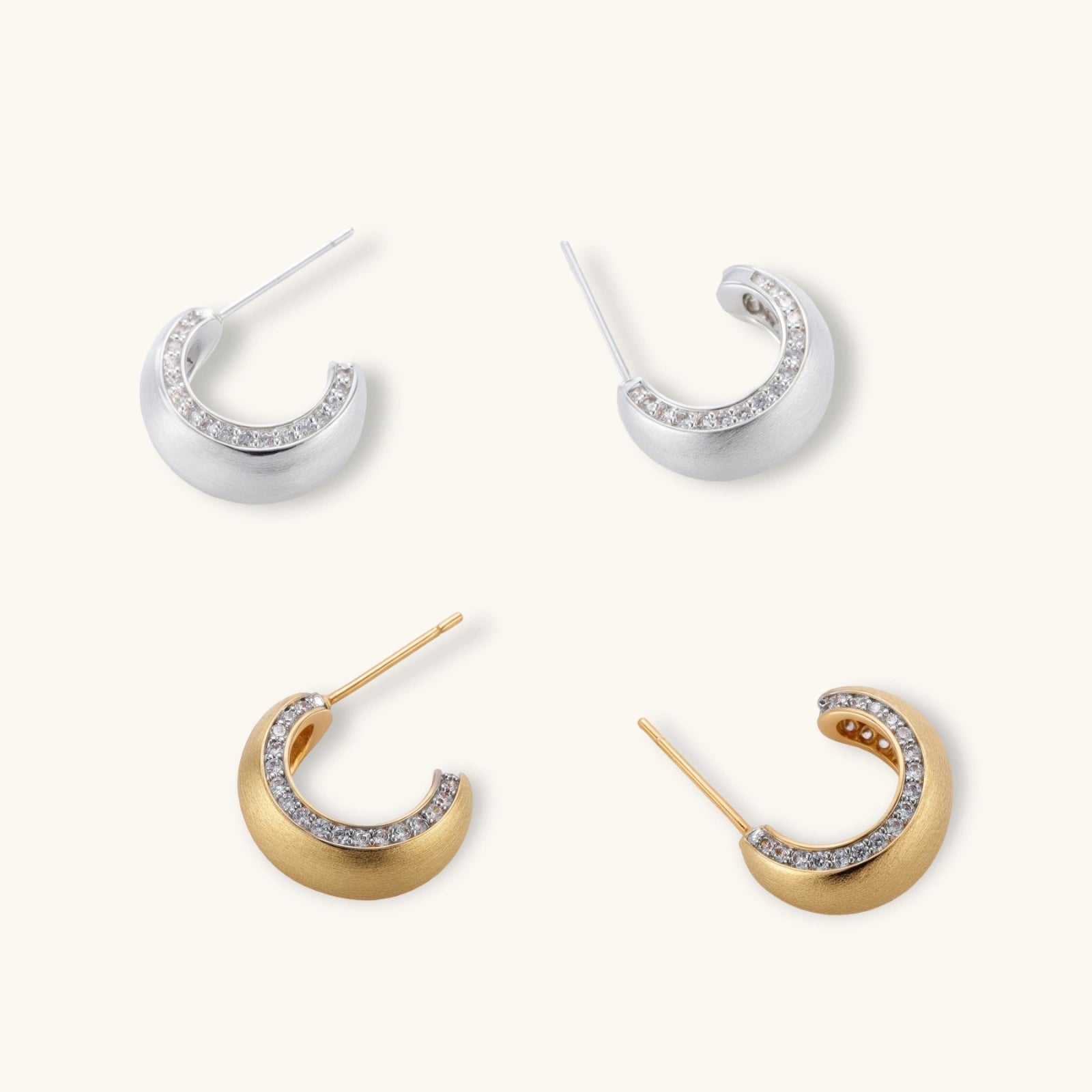 Small gold-plated hoop earrings with crystal accents and brushed finish on white background.