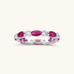 Platinum-plated eternity ring with alternating oval ruby and round clear stones in continuous band setting